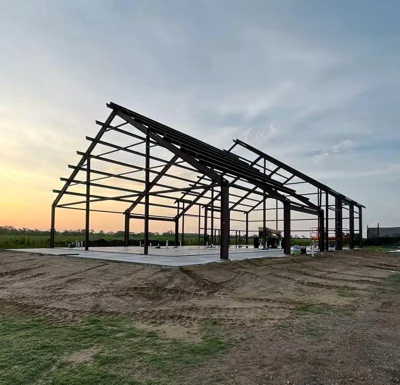 Barndominium frame at sunset in Texas